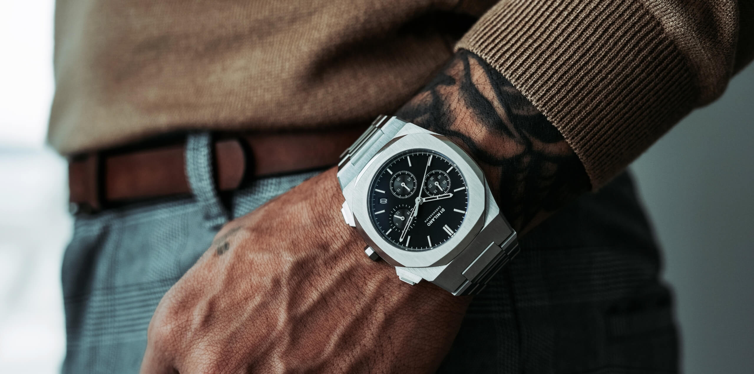 Close up of a man wearing the D1 Milano model timepiece.